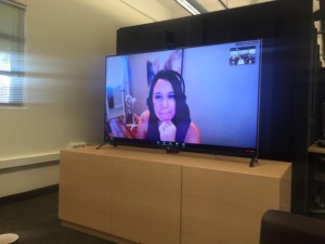 An image showing Michelle's video presence projected on a large monitor.
